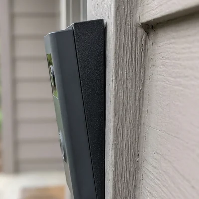 Wedge tilting a doorbell downward toward the step