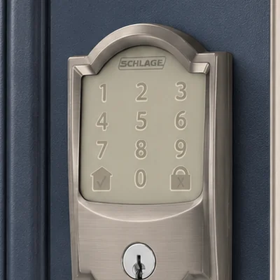 Keypad deadbolt with Camelot trim on the outside of a front door