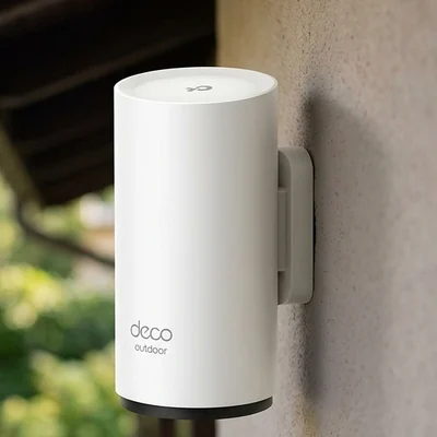 Weatherproof mesh Wi-Fi unit mounted on an exterior wall under an eave